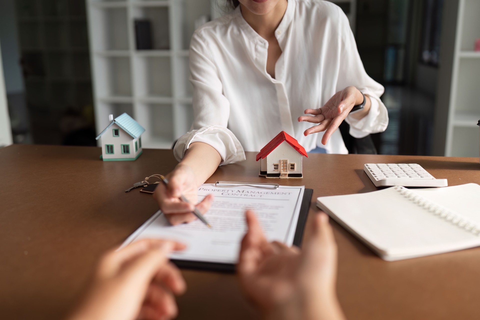 real estate agent discussion to explaining about property investment document with home sales contract and home insurance to customer while businessman asking terms data of contract